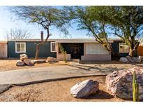 Charming single-story home with desert landscaping and a long driveway leading to the entrance at 2939 E Paradise Ln, Phoenix, AZ 85032