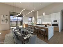 Bright, modern kitchen with sleek countertops, a large island, and expansive windows offering scenic views at 39332 N Old Stage Rd, Cave Creek, AZ 85331