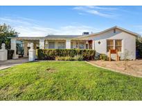 Charming home featuring a well-manicured lawn, classic architecture, and a welcoming entrance at 440 W 1St W St, Mesa, AZ 85201