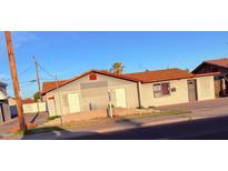 Exterior view of a building with light colored stucco siding and brown roof at 4825 N 35Th Ave, Phoenix, AZ 85017