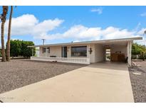 Charming single-story home with a front porch, driveway, and desert landscaping, ideal for comfortable living at 5463 E Albany St, Mesa, AZ 85205