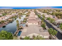 Aerial view of home featuring a pool, water view and lush landscaping at 612 E Riviera Dr, Chandler, AZ 85249