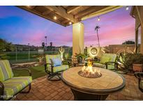 Inviting backyard patio featuring a fire pit, comfortable chairs, and lush landscaping for serene outdoor living at 6202 E Mckellips Rd # 46, Mesa, AZ 85215