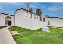 Inviting exterior view of a two-story home with neutral stucco and well-maintained landscaping at 1051 S Dobson Rd # 117, Mesa, AZ 85202