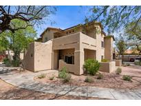 Southwest style home with neutral stucco, front porch, and mature landscaping at 1351 N Pleasant Dr # 1087, Chandler, AZ 85225