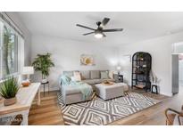 Comfortable living room featuring a gray sectional sofa, modern ceiling fan, and stylish geometric rug at 1531 W Colter St # 7, Phoenix, AZ 85015