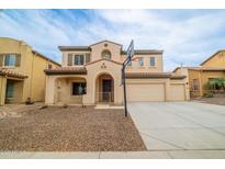 Charming two-story home featuring a three car garage and a well-maintained front yard with a basketball hoop at 16011 W Clinton St, Surprise, AZ 85379