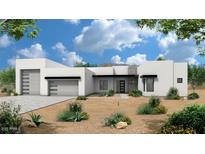 Modern home showcasing a desert landscape, featuring a multi-car garage and stone accents at 1940 E Creek Canyon Rd, Phoenix, AZ 85086