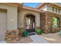 Charming home featuring a stone accented entry gate leading to the courtyard at 30396 N 72Nd Pl, Scottsdale, AZ 85266