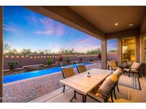 Covered patio overlooking the pool area, ideal for outdoor dining and relaxation at 30396 N 72Nd Pl, Scottsdale, AZ 85266