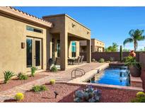 Beautiful backyard pool with a brick patio and desert landscaping creates a private oasis at 30396 N 72Nd Pl, Scottsdale, AZ 85266