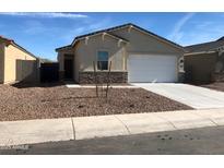 Charming single-story home featuring a neutral color scheme, low-maintenance landscaping, and a convenient two-car garage at 36217 N Urika Dr, San Tan Valley, AZ 85140