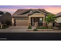 Charming single-Gathering home features a two-car garage, covered entryway, and beautiful desert landscaping at 4156 E Bernice St, Gilbert, AZ 85295