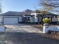 Charming single-story home featuring a paved driveway and attached garage, with desert landscaping at 7636 E Coronado Rd, Mesa, AZ 85207