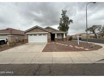 Charming single-story home with well-maintained landscape and a two-car garage at 10463 W Medlock Dr, Glendale, AZ 85307