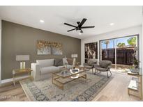 Bright living room featuring contemporary furnishings, stylish rug, and sliding glass doors to the backyard at 1051 S Dobson Rd # 44, Mesa, AZ 85202