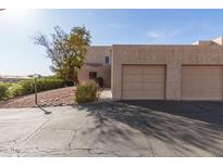 Beige stucco home with a two car garage and a desert landscaped yard at 16616 E Palisades Blvd # 109, Fountain Hills, AZ 85268