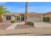 Charming single-story home with desert landscaping, palm trees, and a two-car garage in a desirable community at 17443 N Goldwater Dr, Surprise, AZ 85374