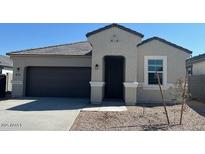 Charming single-story home featuring a two-car garage and simple desert landscaping at 25461 W Graham Trl, Buckeye, AZ 85326