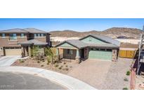 Single-story home with two-car garage, desert landscaping, and brick paved driveway at 33395 N 132Nd Dr, Peoria, AZ 85383