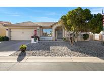 Charming single-story home featuring rock landscaping, a cozy front porch, and a two-car garage at 6520 S Pebble Beach Dr, Chandler, AZ 85249
