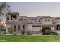 Contemporary two-story home with a landscaped front yard and neutral stucco exterior at 14850 E Grandview Dr # 239, Fountain Hills, AZ 85268