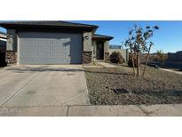 Charming single-Gathering home with a two-car garage and desert landscaping in front at 17308 W Daley Ln, Surprise, AZ 85387