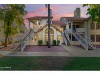 Inviting condo exterior showcasing a well-maintained facade, beautiful landscaping, and a charming walkway at 19820 N 13Th Ave # 169, Phoenix, AZ 85027