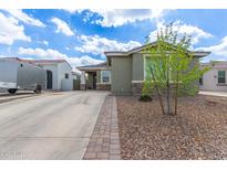 Charming single-story home features a well-maintained front yard and long driveway at 265 W Rainbow Bridge Ln, San Tan Valley, AZ 85140