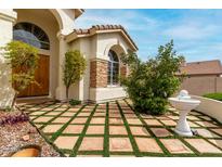 Charming front yard featuring a unique tiled lawn and a decorative fountain at 3110 E Desert Flower Ln, Phoenix, AZ 85048