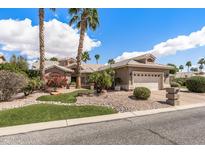 Charming single-story home featuring a two-car garage and meticulously landscaped front yard at 3801 N 154Th Ln, Goodyear, AZ 85395