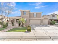 Charming two-story home featuring a spacious three-car garage and beautiful landscaping at 41213 N Linden St, Queen Creek, AZ 85140