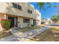 Charming townhome featuring a landscaped front yard and covered entry, offering a warm and inviting curb appeal at 6837 E Osborn Rd # F, Scottsdale, AZ 85251