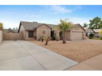 Beautiful single-story home with desert landscaping, a two-car garage, extended driveway, and neutral-colored exterior at 711 W Loughlin Dr, Chandler, AZ 85225