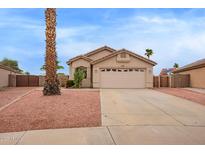 Single-story home boasts desert landscaping, a tile roof, and a spacious two-car garage at 9176 W Calavar Rd, Peoria, AZ 85381