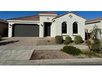 Charming single-story home with a well-maintained front yard and a two car garage at 9804 E Red Giant Dr, Mesa, AZ 85212