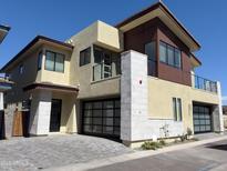 Modern two-story home with a brick driveway and dual garage doors at 1 Easy St # 11, Carefree, AZ 85377