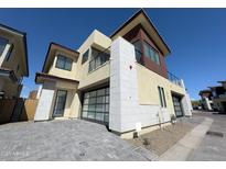 Contemporary two-story home with a glass garage door and stone accents at 1 Easy St # 7, Carefree, AZ 85377