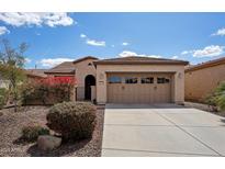 Charming home featuring a two-car garage, desert landscaping and a secure gated entrance at 12915 W Lone Tree Trl, Peoria, AZ 85383