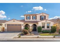 Charming two-story home with a well-manicured lawn, desert landscaping and a two car garage at 19699 E Apricot Ln, Queen Creek, AZ 85142