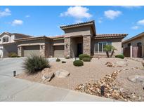 Beautiful single-story home with stone accents, desert landscaping, and a three-car garage at 2414 W Barbie Ln, Phoenix, AZ 85085