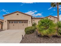 Charming home with a two-car garage, desert landscaping, and a tile roof against a beautiful blue sky at 27792 N 129Th Ln, Peoria, AZ 85383