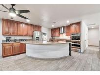 Spacious kitchen with a large island, stainless steel appliances, and wood cabinets at 3224 E Sweetwater Ave, Phoenix, AZ 85032