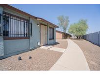 Charming one-story home featuring a secure front entrance with metal bars and a well-maintained walkway at 3646 N 67Th Ave # 12, Phoenix, AZ 85033