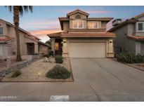 Charming two-story home with a tile roof, front yard landscaping, and a two-car garage at 4072 E Mountain Vista Dr, Phoenix, AZ 85048