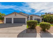 Stunning single-story home with a three-car garage and well-manicured landscaping in a suburban neighborhood at 6155 E Karen Dr, Scottsdale, AZ 85254