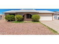 Charming single-story home with low-maintenance landscaping and a two-car garage at 716 W Nopal Pl, Chandler, AZ 85225