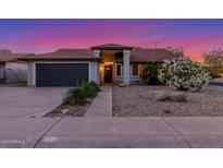 Charming single-story home featuring a well-maintained lawn, two car garage and inviting entrance at 756 E Appaloosa Rd, Gilbert, AZ 85296