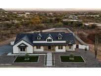 Inviting exterior elevation showcases a modern farmhouse design with a beautifully landscaped front yard at 8147 E Redberry --, Mesa, AZ 85207