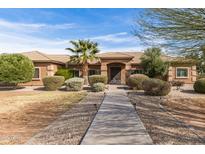 Charming home featuring a landscaped front yard, desert landscaping and a inviting walkway to the front entrance at 838 W Via De Palmas --, San Tan Valley, AZ 85140